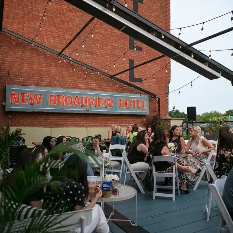 The Lincoln Terrace rooftop at the Broadview Hotel with people dining and talking at tables