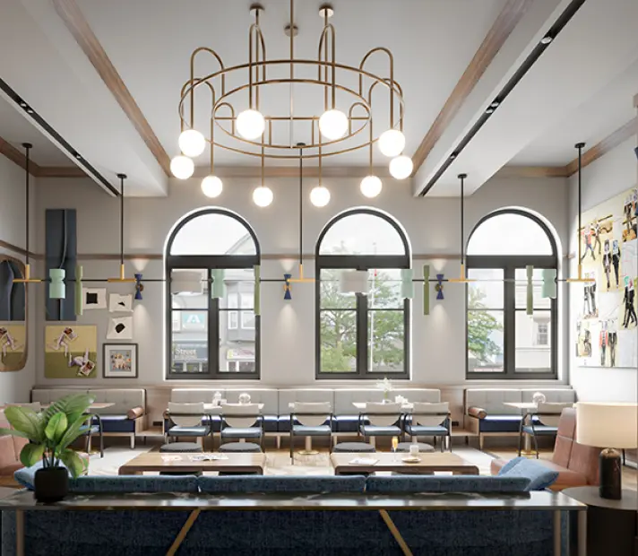 Interior photo of brightly lit guest lounge at the Postmark Hotel with booth seating, large windows, and wall art
